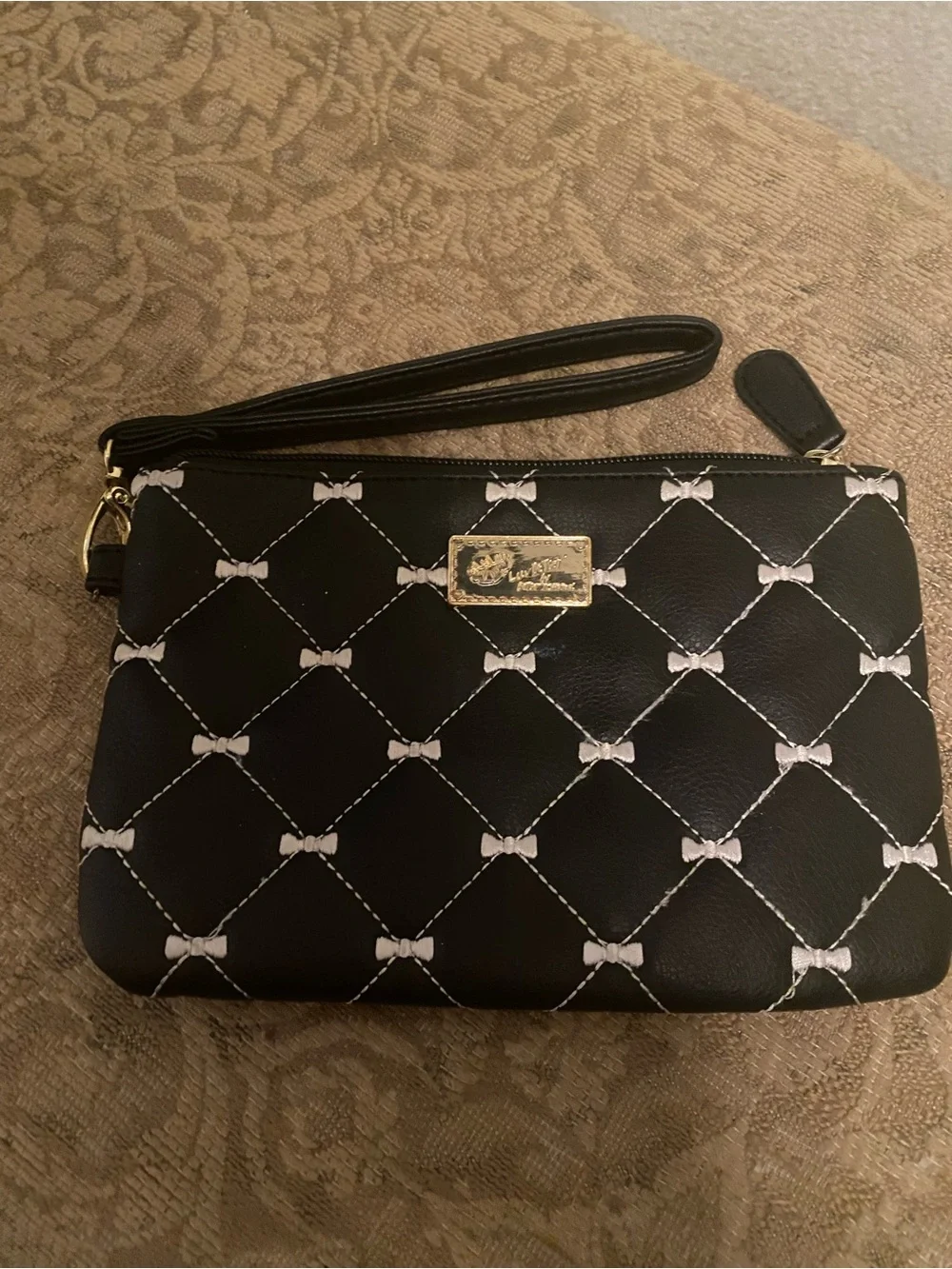 Betsey Johnson Black Quilted Bow-Print Wristlet with Gold Plaque